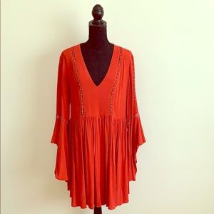 Reddish orange blouse/dress.